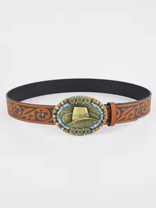 Detail of western leather belt with embossed texture and cowboy hat buckle with blue beads