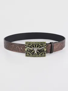 Detail of western leather belt with embossed patterns and bull head metal buckle