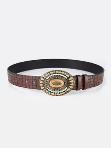 Detail of retro buckle with turquoise stone on dark brown faux leather crocodile belt