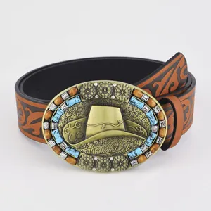 Western bohemian brown embossed leather belt featuring large golden cowboy hat buckle
