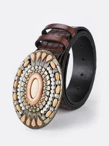 Detail of vintage bohemian belt with turquoise buckle and faux pearls on brown PU leather