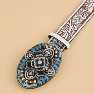 Boho vintage leather belt featuring a large floral buckle with turquoise accents