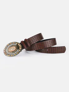 Macro detail of retro buckle with pearls and amber gems on brown faux leather belt