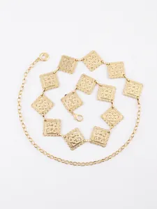 Macro detail of square embossed golden link waist chain with vintage pattern and lobster clasp