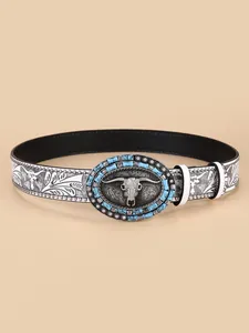 Detail of western belt buckle with longhorn bull head relief and turquoise stones