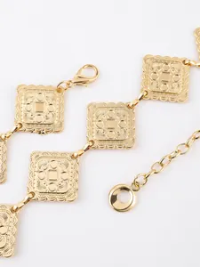 Detail of square embossed gold chain links with scalloped edges and lobster clasp