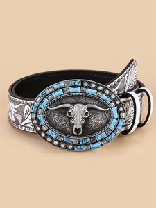 Detail of western belt buckle with bull skull relief, turquoise stones and silver rivets