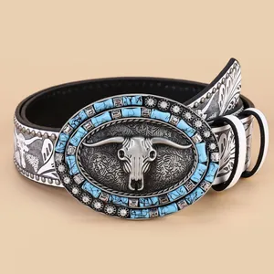 Western style belt featuring a bull skull metal buckle with turquoise and rhinestones