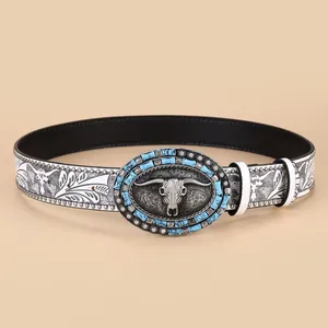 Western cowboy belt with floral patterns, white leather, and bull skull buckle with turquoise