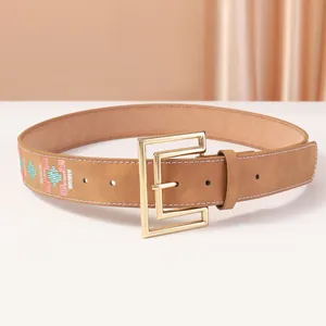 Brown leather belt with geometric ethnic embroidery and a golden buckle for women