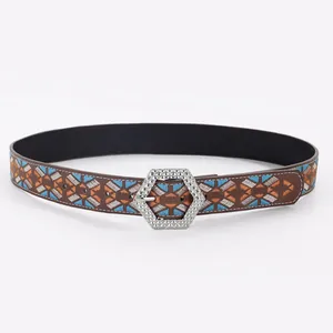 Detail of ethnic belt showing geometric embroidery and studded silver hexagonal buckle