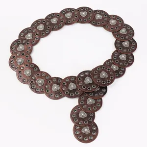 Western style brown leather belt with hollow circular discs and silver heart studs