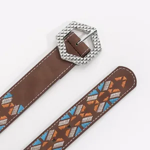Brown leather belt with embroidered geometric patterns and a textured silver hexagon buckle