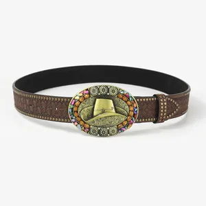 Detail of vintage brown leather belt with ornate bronze buckle and cowboy hat motif