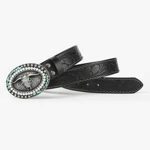 Detail of western leather belt with embossed floral patterns and turquoise skull buckle