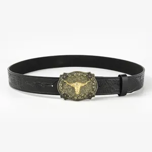 Detail of western cowboy belt with embossed floral patterns and gold bull head buckle