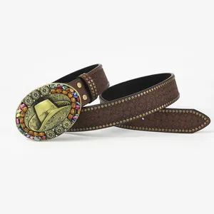 Detail of vintage western leather belt with floral embossing and bronze rivet studs