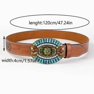 Detail of western cowboy belt with embossed leather and turquoise floral metal buckle