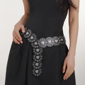 Detail of western cowboy belt featuring black leather discs and silver heart buckles