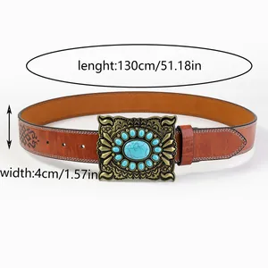 Detail of western cowboy belt featuring carved buckle with turquoise and embossed leather