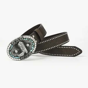 Close-up of vintage brown leather belt with turquoise buckle and embossed floral patterns