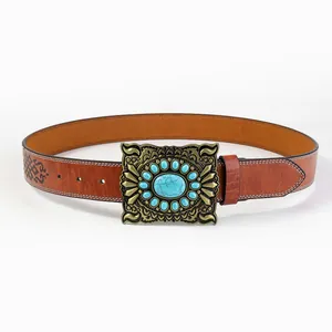 Close-up of Western vintage leather belt featuring turquoise buckle and embossed pattern