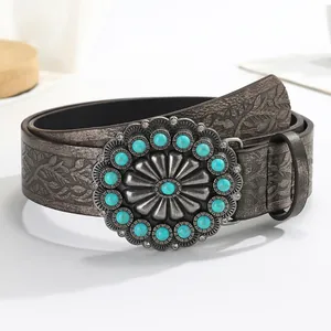 Vintage western leather belt with embossed floral patterns and turquoise buckle