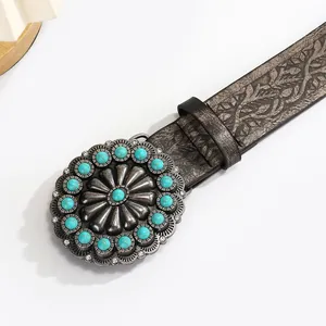 Vintage western leather belt with embossed floral patterns and turquoise buckle