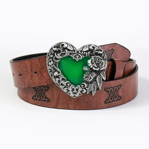 Vintage red-brown belt with embossed patterns and heart buckle with green gemstone
