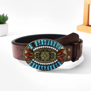 Brown vintage western cowboy belt with embossed leather and ornate floral turquoise buckle