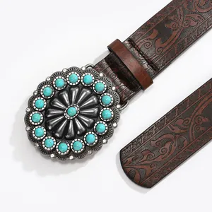Vintage western leather belt with embossed floral patterns and turquoise metal buckle
