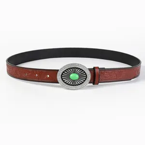 Detail of red-brown embossed leather belt with silver oval buckle and green gemstone
