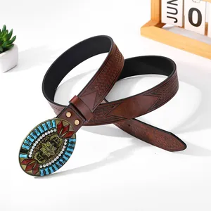 Detail of Western cowboy leather belt with floral engraving and gemstone buckle