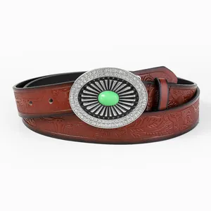 Detail of red-brown leather belt with western totem embossing and silver oval buckle