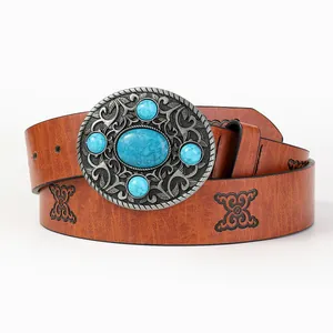 Detail of vintage embossed belt with large silver buckle and blue turquoise stones