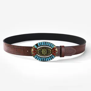 Detail of vintage Western belt buckle with turquoise, red gems and floral engraving