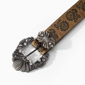 Detail of bohemian leather belt featuring a vintage silver buckle with sparkling rhinestones