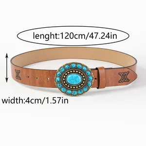 Detail of vintage brown belt with turquoise buckle and embossed pattern, 4cm wide