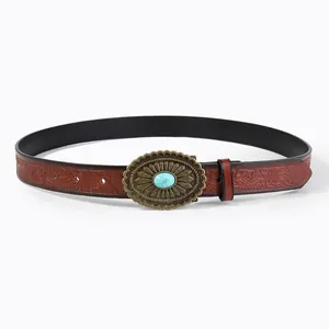 Close-up of vintage Western belt with floral embossing and bronze turquoise buckle