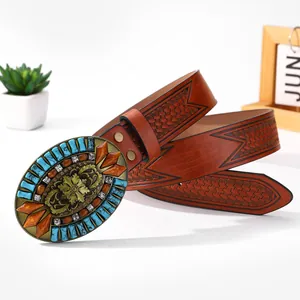 Detail of western belt featuring bronze floral buckle with turquoise and amber stones