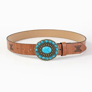 Detail of vintage brown leather belt with turquoise buckle and embossed patterns