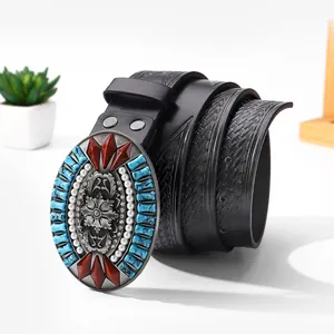Detail of bohemian leather belt with vintage floral embossing and turquoise inlay buckle