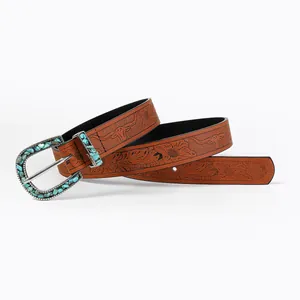 Detail of bohemian brown leather belt with floral embossing and turquoise inlay