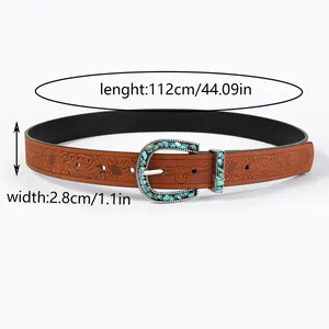 Close-up of brown leather belt with floral embossing and turquoise inlay buckle
