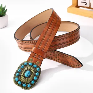 Bohemian brown leather belt with blue turquoise buckle and gold studs on white background