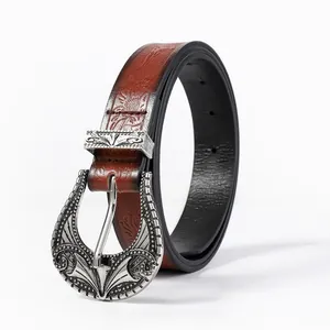 Detail of vintage embossed faux leather belt with ornate silver engraved buckle