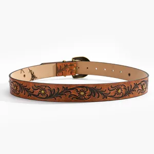 Vintage brown embossed leather belt with floral patterns and bronze rivets on white background