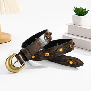 Vintage western leather belt with amber beads and horseshoe buckle on white surface