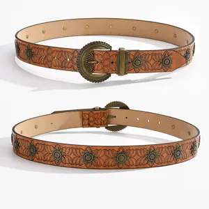 Vintage brown leather belt with floral embossing and brass sun rivets for a Western look