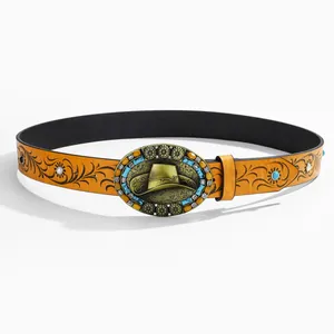 Detail of western cowboy belt with embossed floral pattern and turquoise buckle